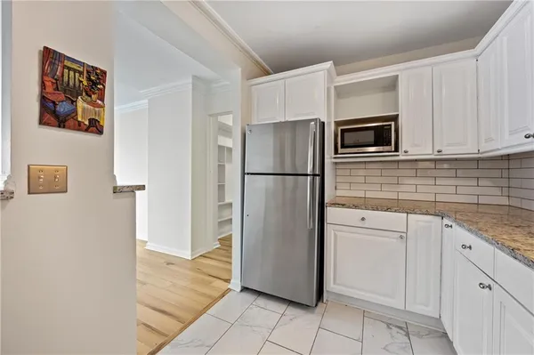 a kitchen with stainless steel appliances granite countertop a refrigerator and a sink