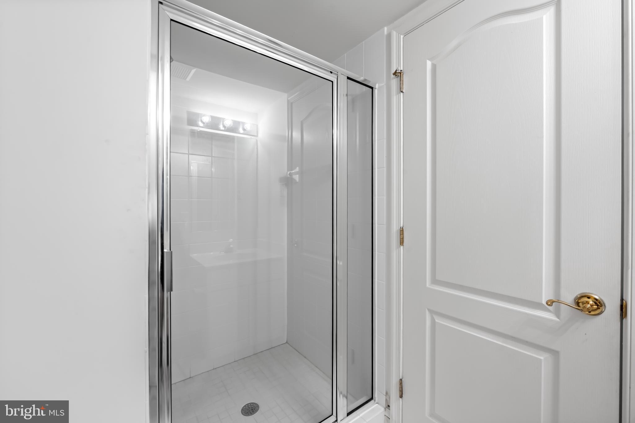 24 Roland Green, Unit 12 Baltimore, MD 21210 - Photo 39 of 53 a bathroom with a glass shower door