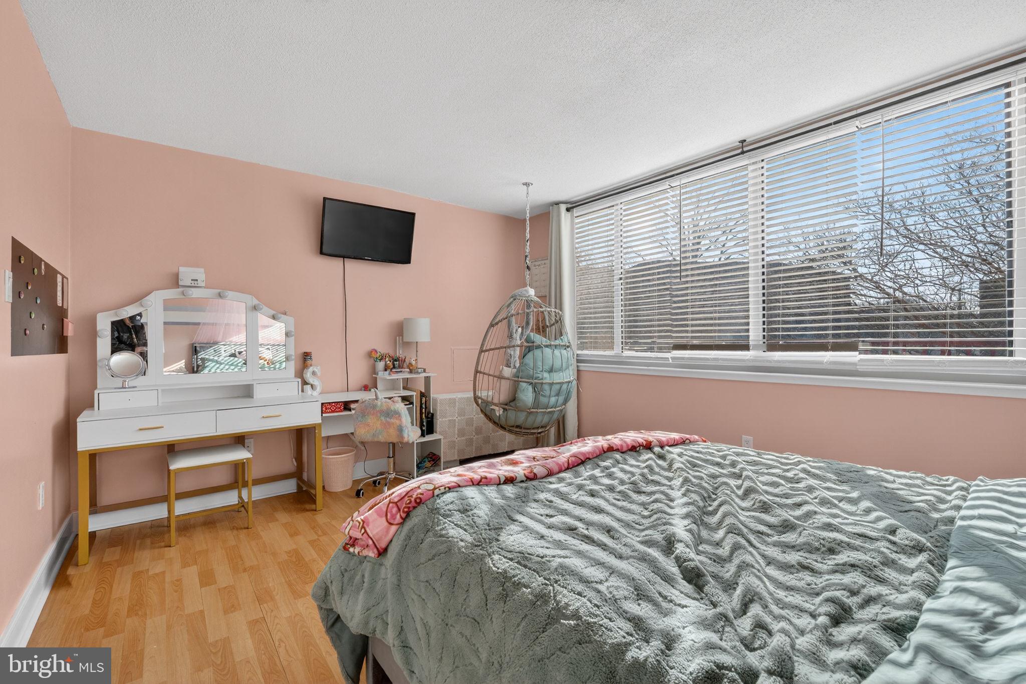 1220 Blair Mill Road, Unit 205 Silver Spring, MD 20910 - Photo 19 of 31 a bedroom with a bed and a table in it