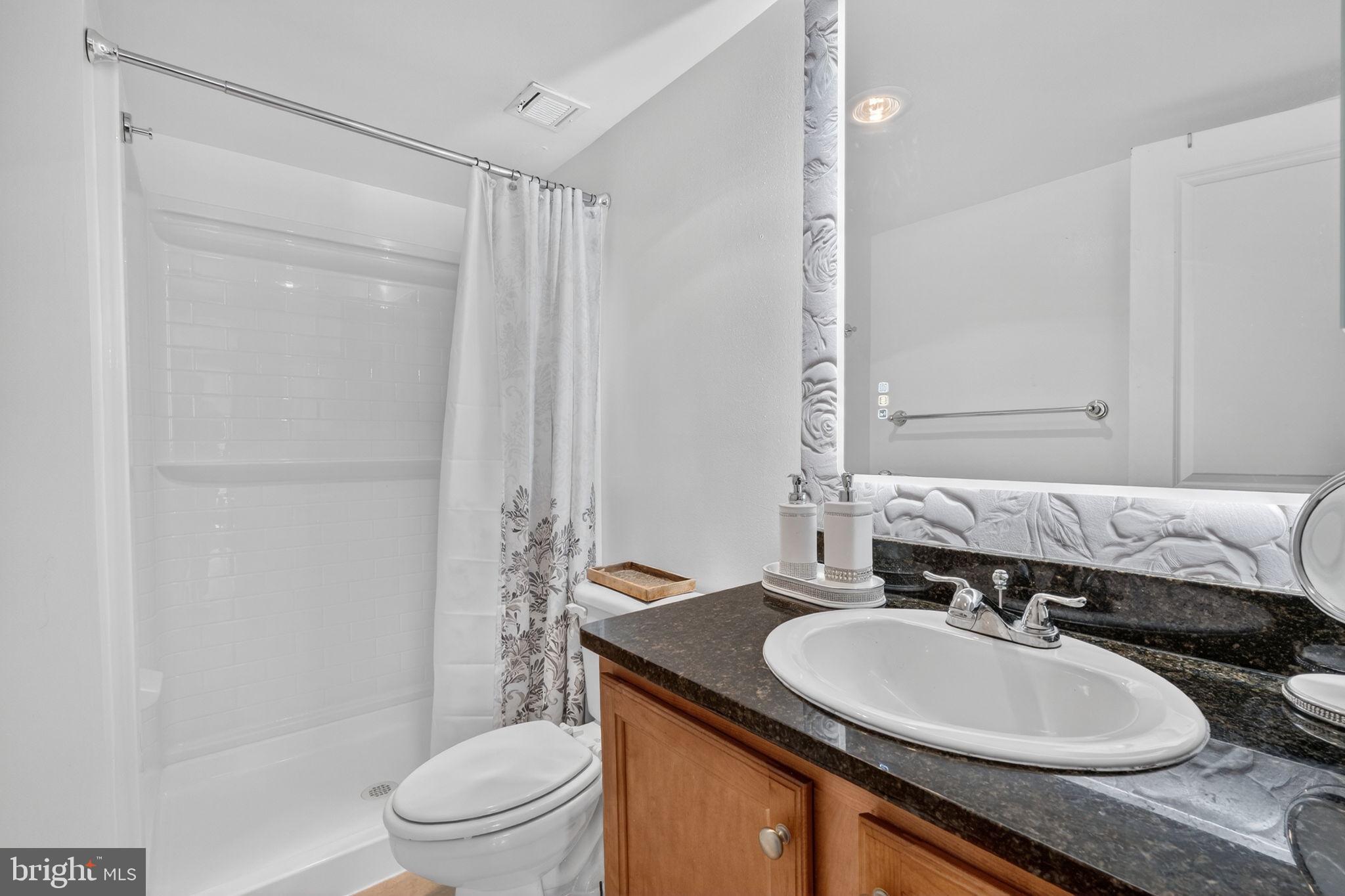 1220 Blair Mill Road, Unit 205 Silver Spring, MD 20910 - Photo 23 of 31 a bathroom with a sink and a mirror