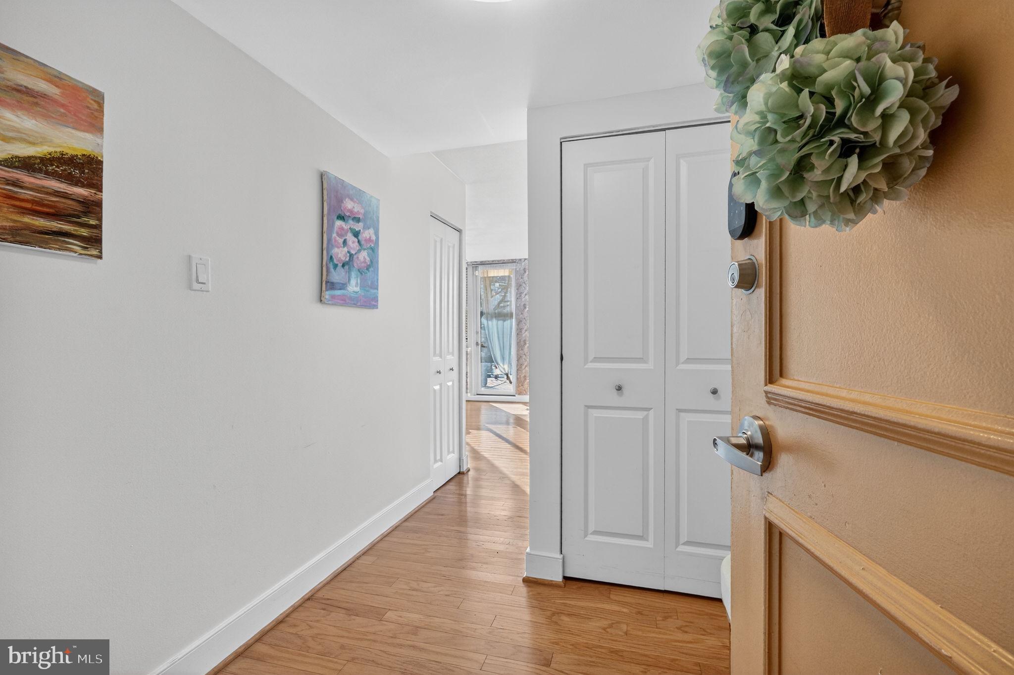 1220 Blair Mill Road, Unit 205 Silver Spring, MD 20910 - Photo 3 of 31 a view of a hallway with wooden floor and closet