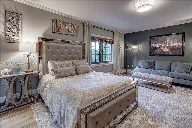 a spacious bedroom with a bed and couch