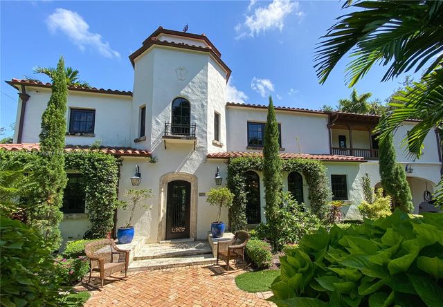 a backyard of a house with a fountain
