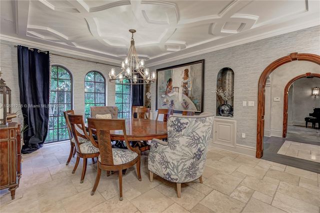 a view of a dining room with furniture and a chandelier