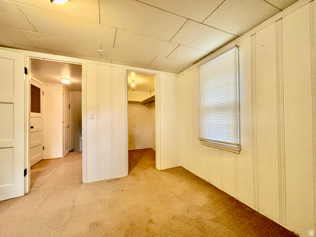 704 North 200 East Logan, UT 84321 - Photo 14 of 24 Unfurnished bedroom featuring light colored carpet and a walk in closet