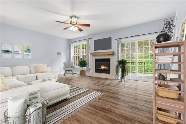 a living room with furniture fireplace and window