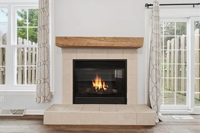 a living room with a fireplace and a window