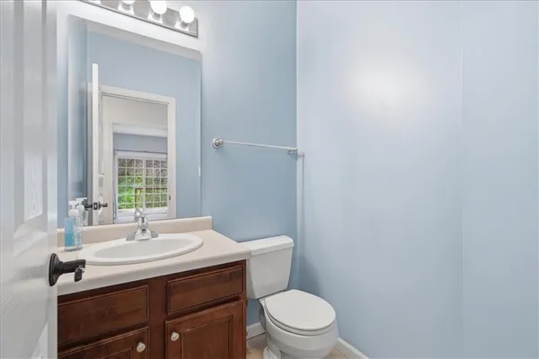 a bathroom with a sink a toilet and mirror