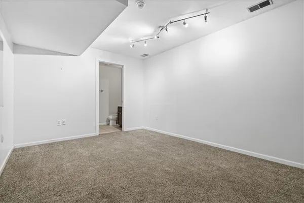 an empty room with an entryway and shower