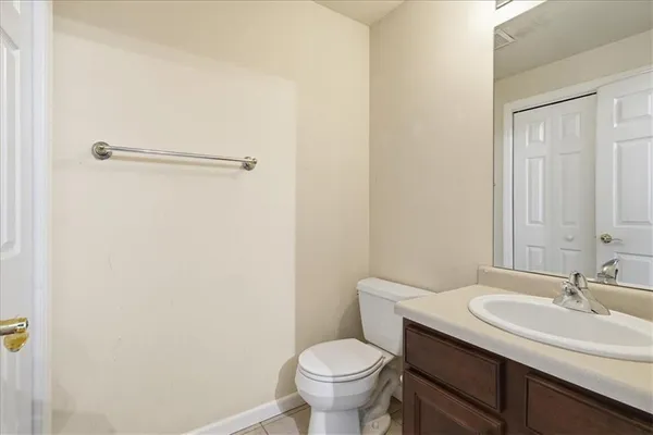 a bathroom with a sink toilet and a mirror
