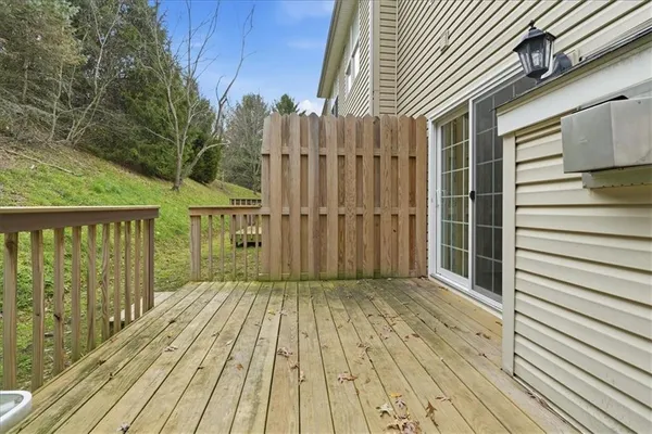 a view of a wooden deck besides a house