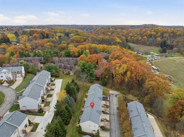 an aerial view of residential houses with outdoor space