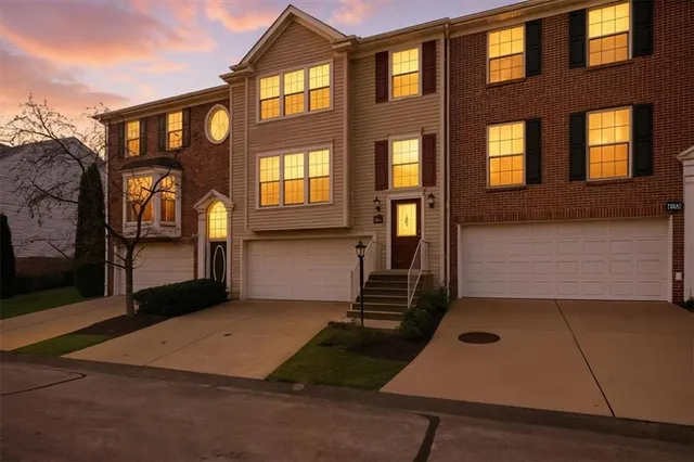 a front view of a house with large windows