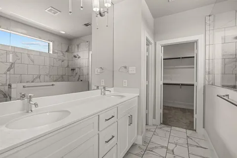 a bathroom with a sink double vanity and a mirror
