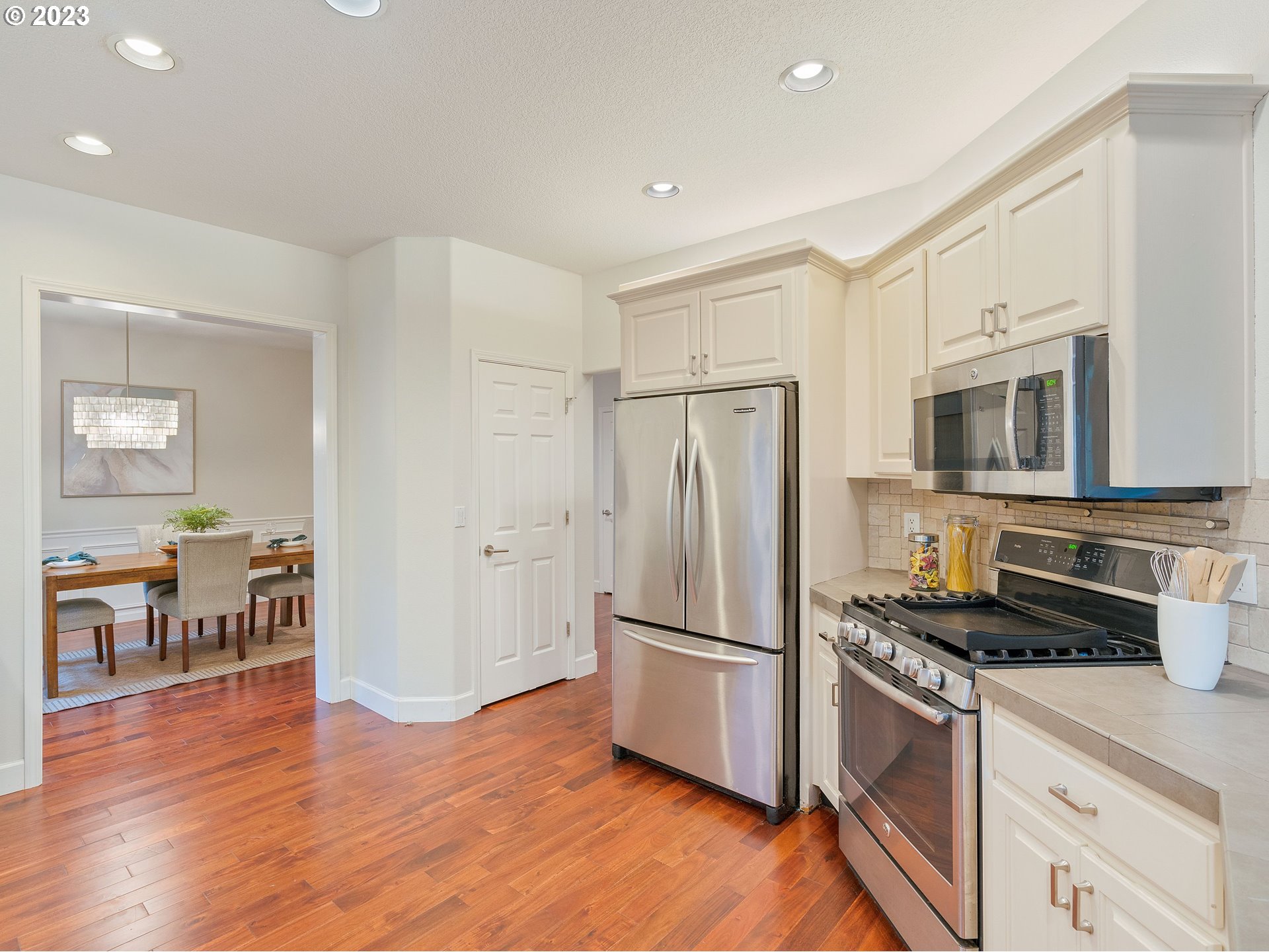 11320 Northwest Kearney Street Portland, OR 97229 - Photo 12 of 16 a kitchen with stainless steel appliances a refrigerator stove and microwave