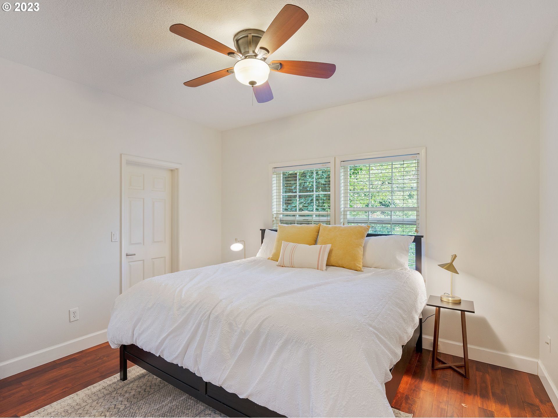 11320 Northwest Kearney Street Portland, OR 97229 - Photo 2 of 16 a bedroom with a large bed and a chandelier