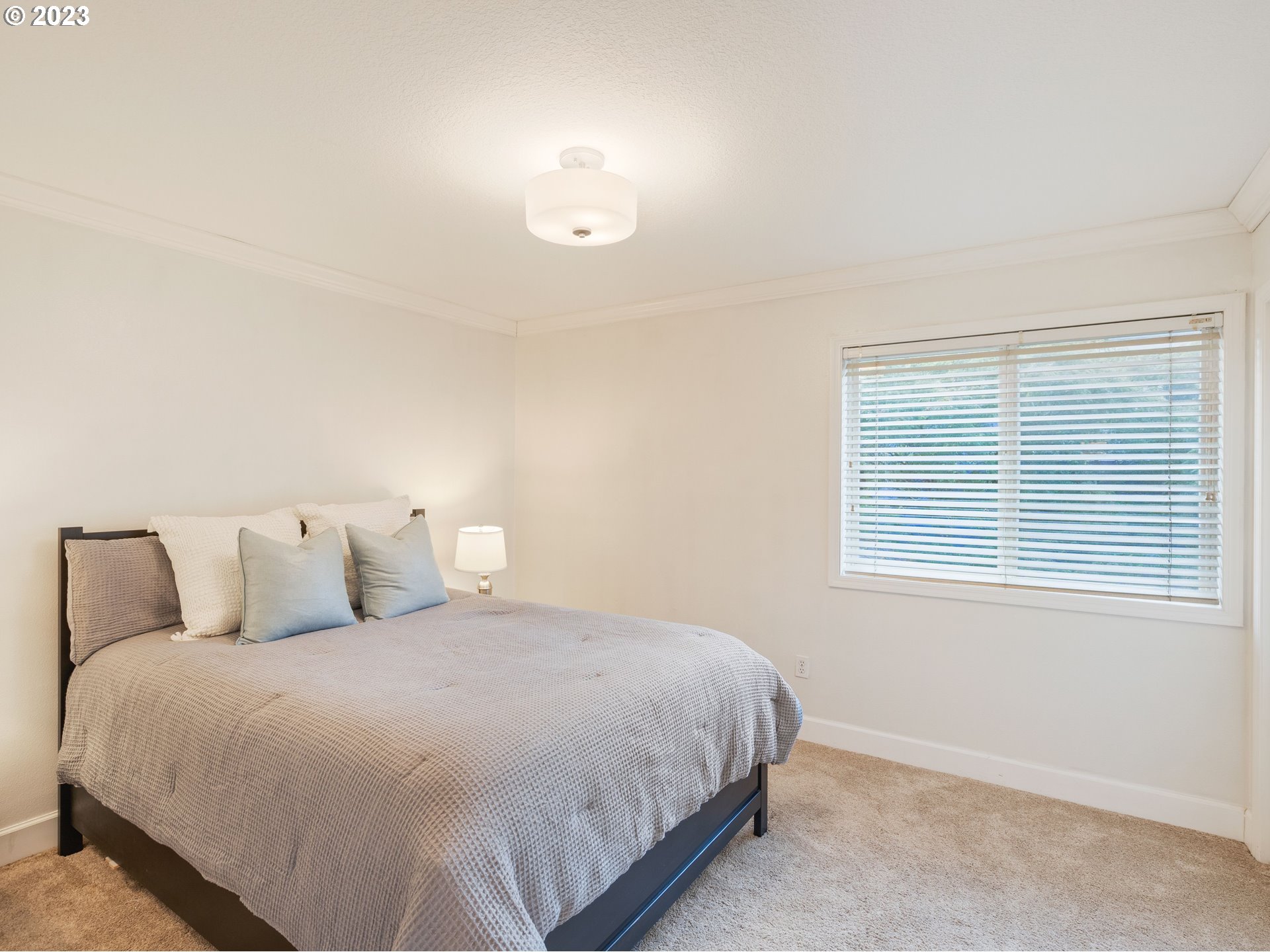 11320 Northwest Kearney Street Portland, OR 97229 - Photo 7 of 16 a bedroom with a bed and a window