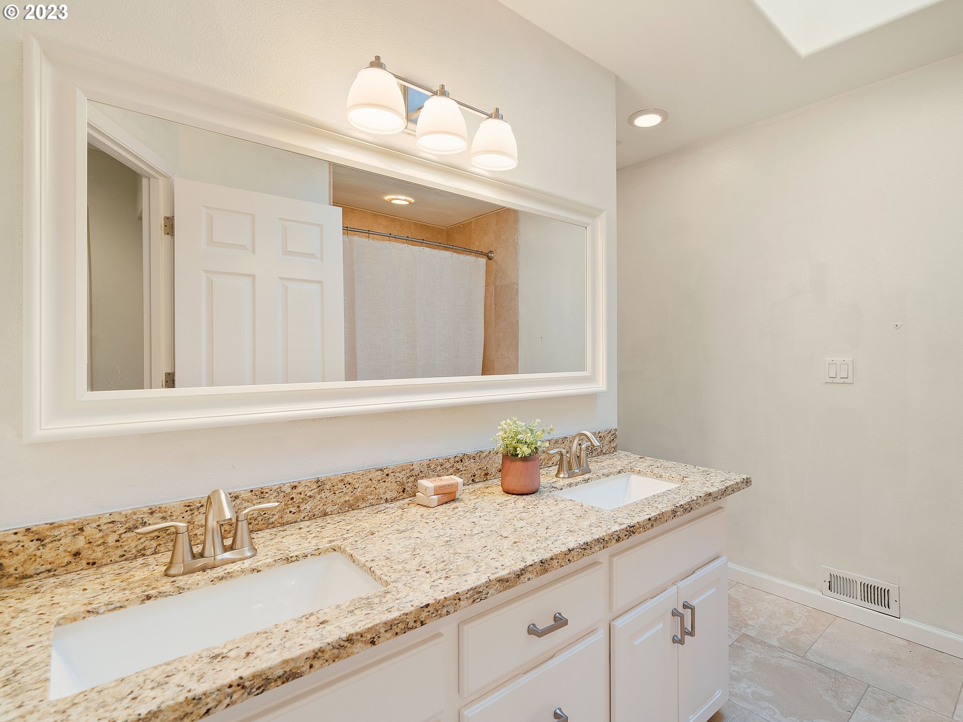 11320 Northwest Kearney Street Portland, OR 97229 - Photo 8 of 16 a bathroom with a granite countertop sink and a mirror
