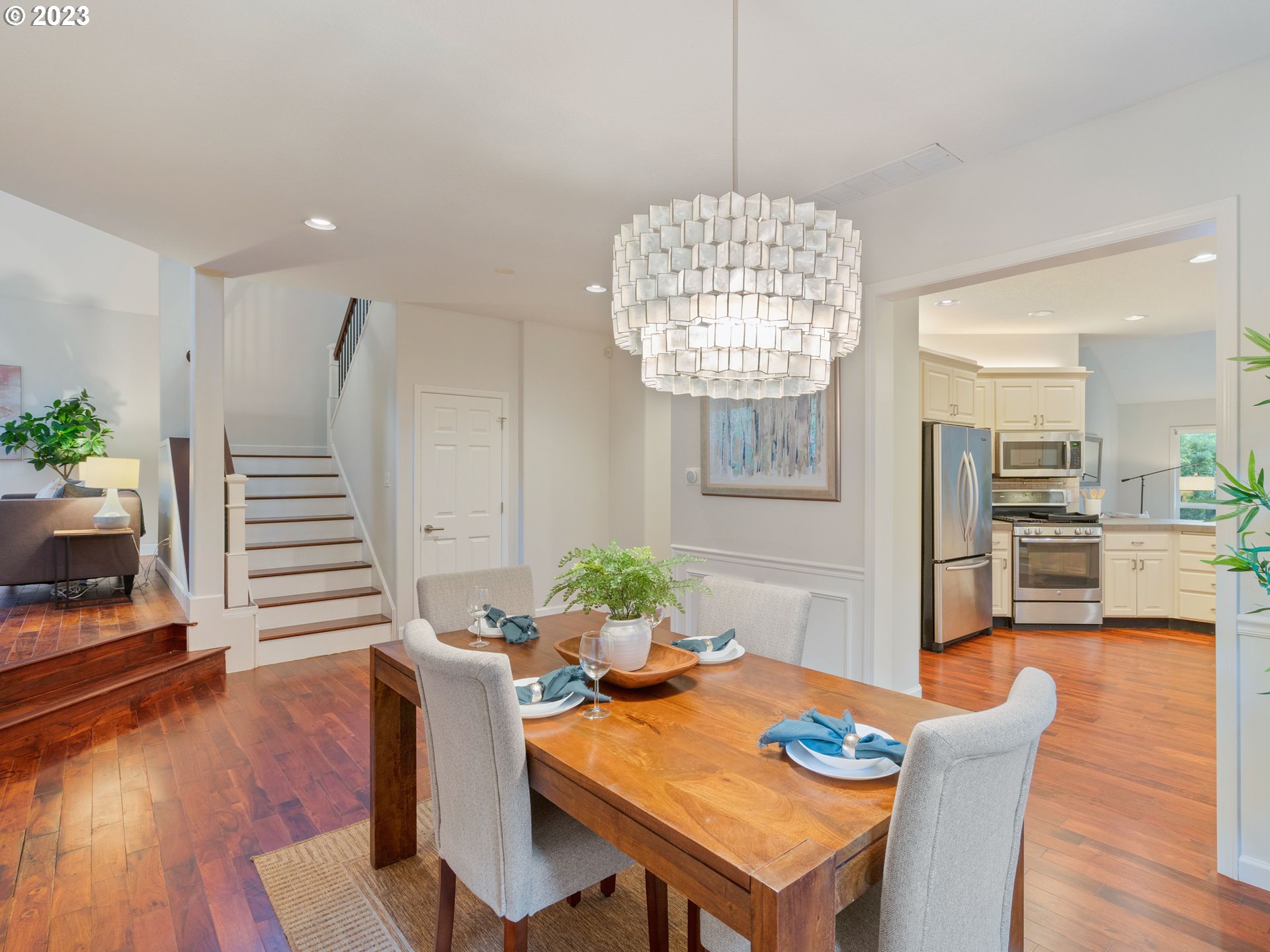 11320 Northwest Kearney Street Portland, OR 97229 - Photo 10 of 16 a view of a dining room with furniture a chandelier and wooden floor