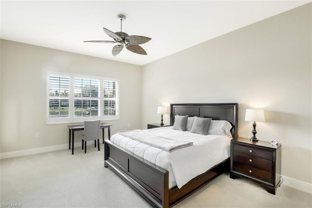 9224 Campanile Circle, Unit 101 Naples, FL 34114 - Photo 19 of 32 a bedroom with a bed and a table with chair