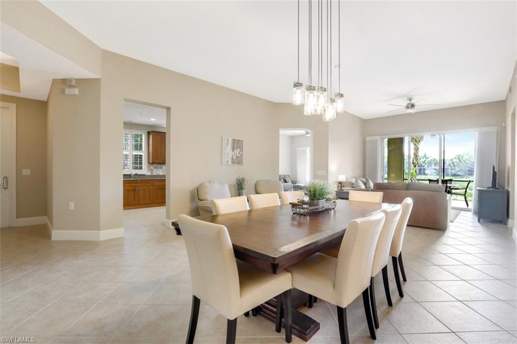 9224 Campanile Circle, Unit 101 Naples, FL 34114 - Photo 2 of 32 a view of a dining room with furniture and a chandelier