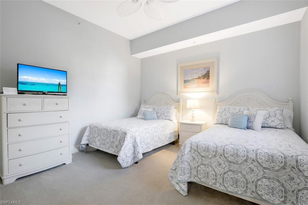 9224 Campanile Circle, Unit 101 Naples, FL 34114 - Photo 21 of 32 a bedroom with two beds and painting on the wall