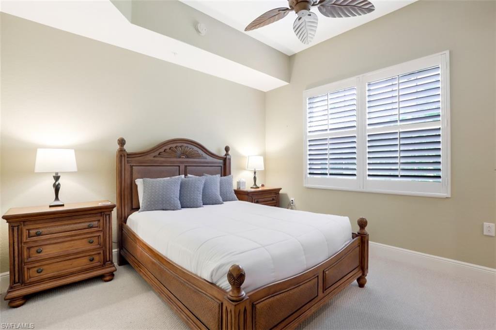 9224 Campanile Circle, Unit 101 Naples, FL 34114 - Photo 23 of 32 a bedroom with a bed and a ceiling fan