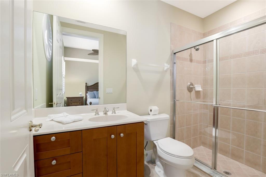 9224 Campanile Circle, Unit 101 Naples, FL 34114 - Photo 24 of 32 a bathroom with a sink a toilet and shower