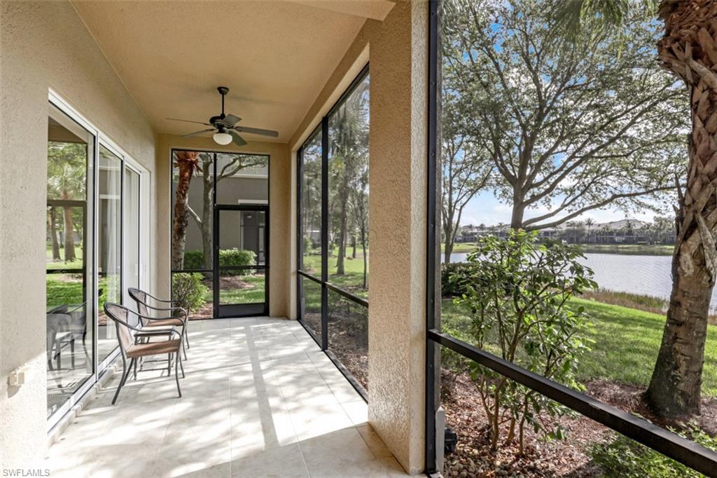 9224 Campanile Circle, Unit 101 Naples, FL 34114 - Photo 27 of 32 a porch with a table and chairs in patio