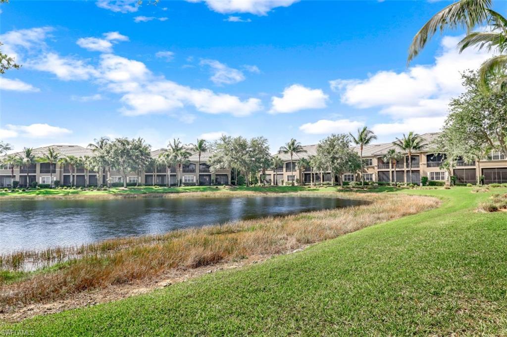 9224 Campanile Circle, Unit 101 Naples, FL 34114 - Photo 28 of 32 a view of a lake with houses in the background