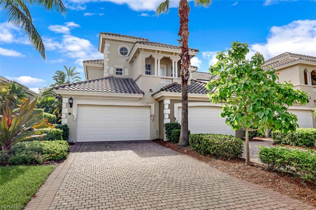 9224 Campanile Circle, Unit 101 Naples, FL 34114 - Photo 30 of 32 a front view of a house with a yard and garage