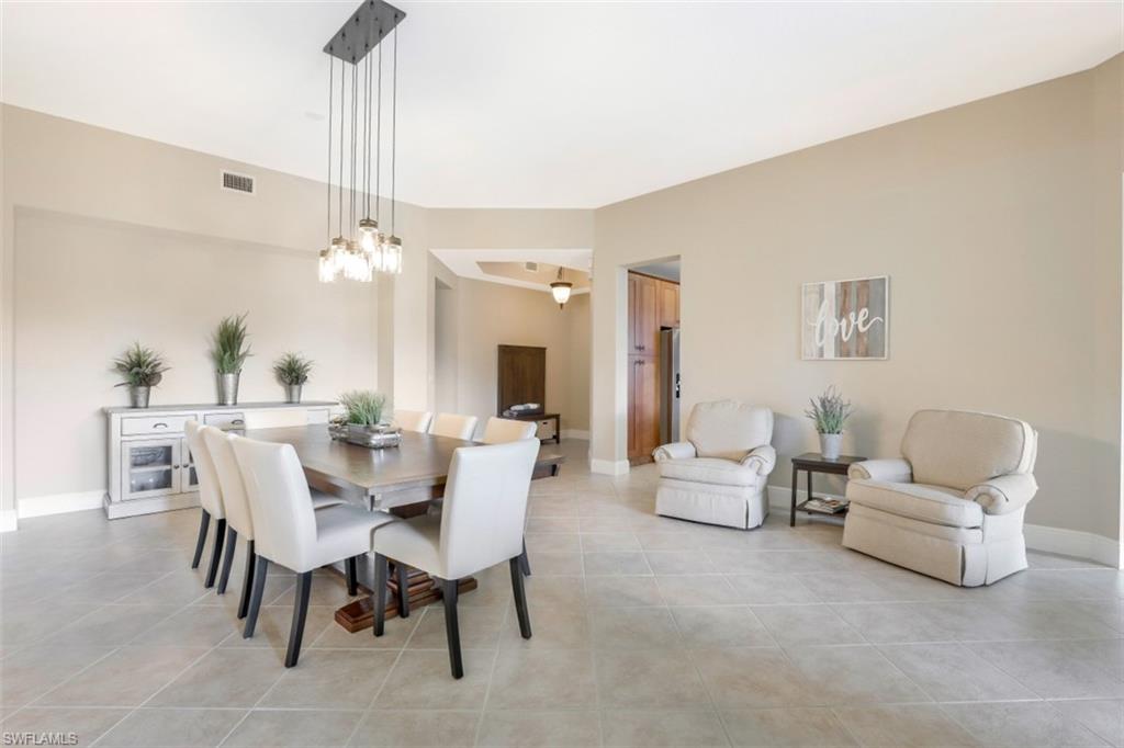 9224 Campanile Circle, Unit 101 Naples, FL 34114 - Photo 4 of 32 a view of a dining room with furniture