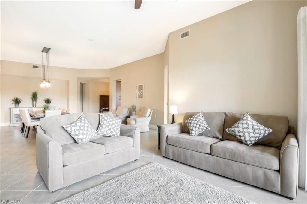 9224 Campanile Circle, Unit 101 Naples, FL 34114 - Photo 6 of 32 a living room with furniture and white walls