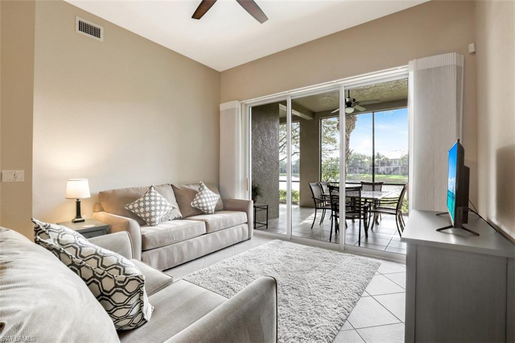 9224 Campanile Circle, Unit 101 Naples, FL 34114 - Photo 8 of 32 a living room with furniture and a large window