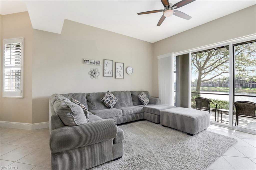 9224 Campanile Circle, Unit 101 Naples, FL 34114 - Photo 9 of 32 a living room with furniture and a large window