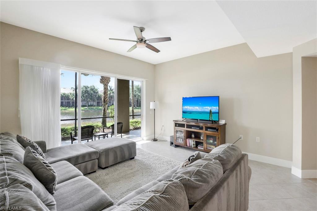 9224 Campanile Circle, Unit 101 Naples, FL 34114 - Photo 10 of 32 a living room with furniture and a flat screen tv