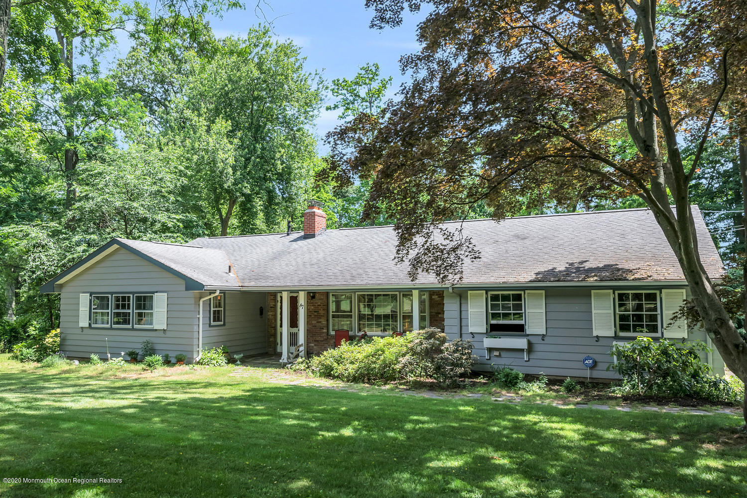 a front view of a house with a garden and porch