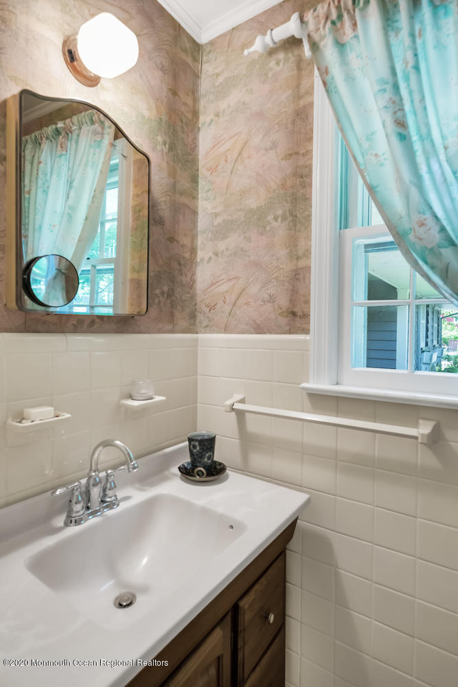 87 Bruce Road Red Bank, NJ 07701 - Photo 13 of 19 a bathroom with a sink and a mirror