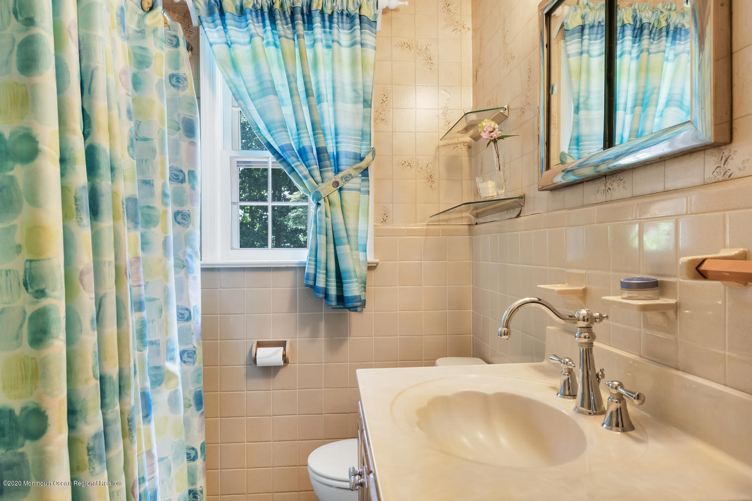 87 Bruce Road Red Bank, NJ 07701 - Photo 16 of 19 a bathroom with a sink a toilet and shower curtain