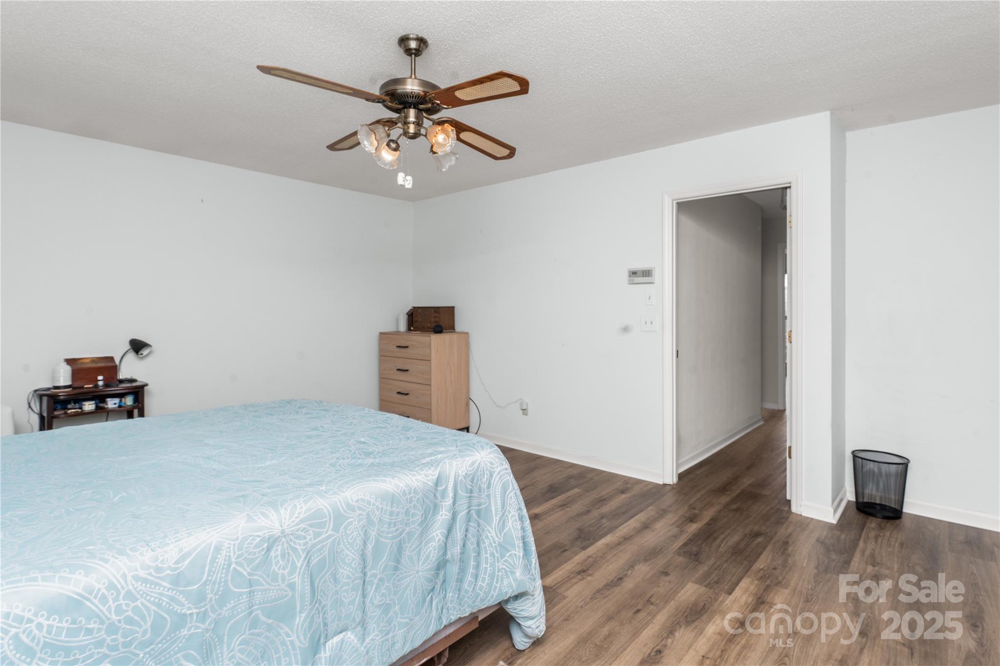 3614 McKee Road Charlotte, NC 28270 - Photo 13 of 29 a bedroom with a bed and a chandelier