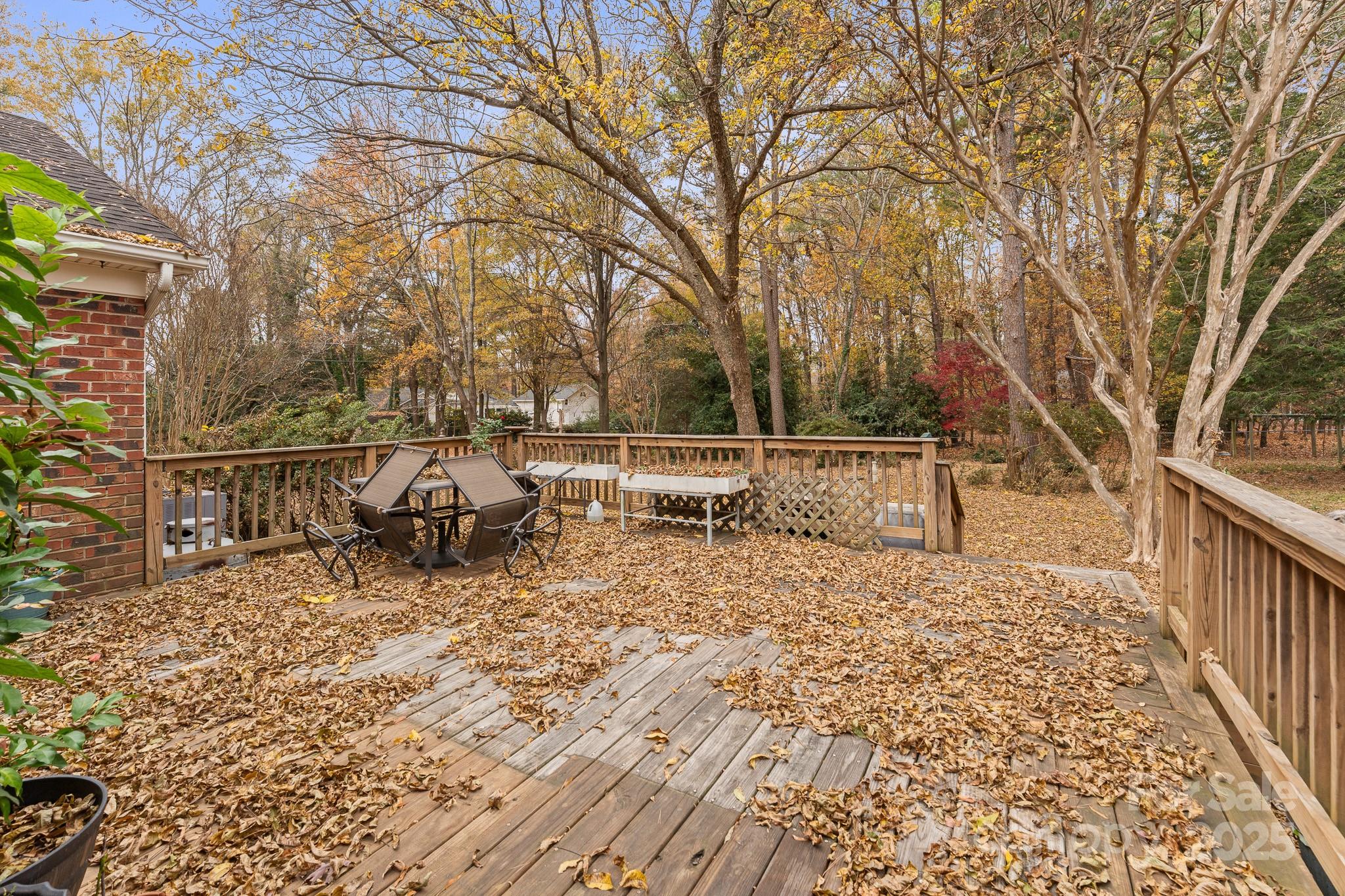 3614 McKee Road Charlotte, NC 28270 - Photo 27 of 29 a view of a roof deck with table and chairs and wooden fence