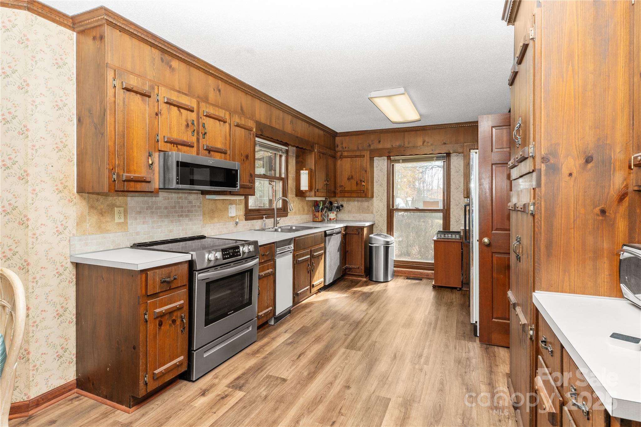 3614 McKee Road Charlotte, NC 28270 - Photo 5 of 29 a kitchen with stainless steel appliances granite countertop wooden cabinets a stove top oven a sink and dishwasher