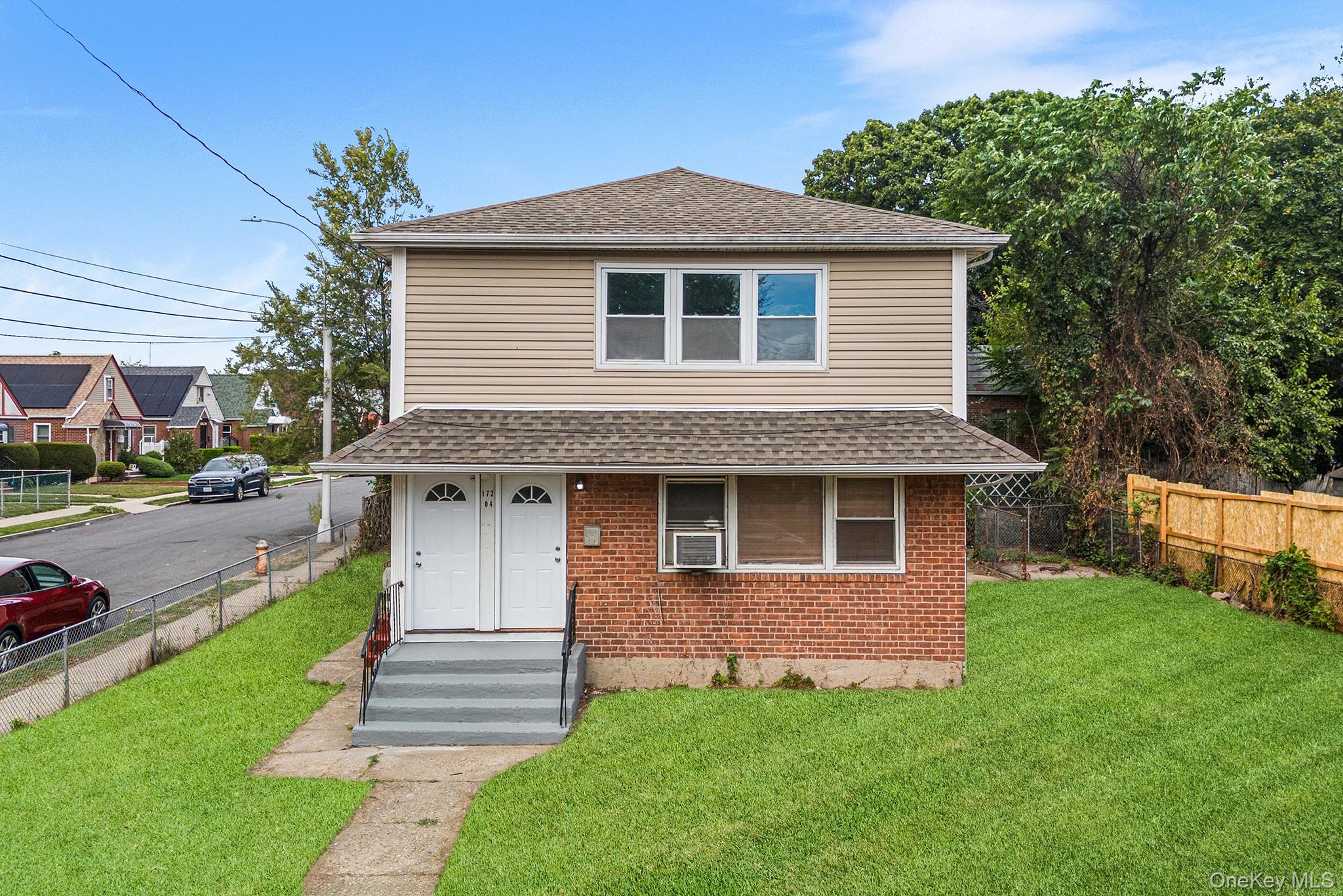 a front view of a house with a yard