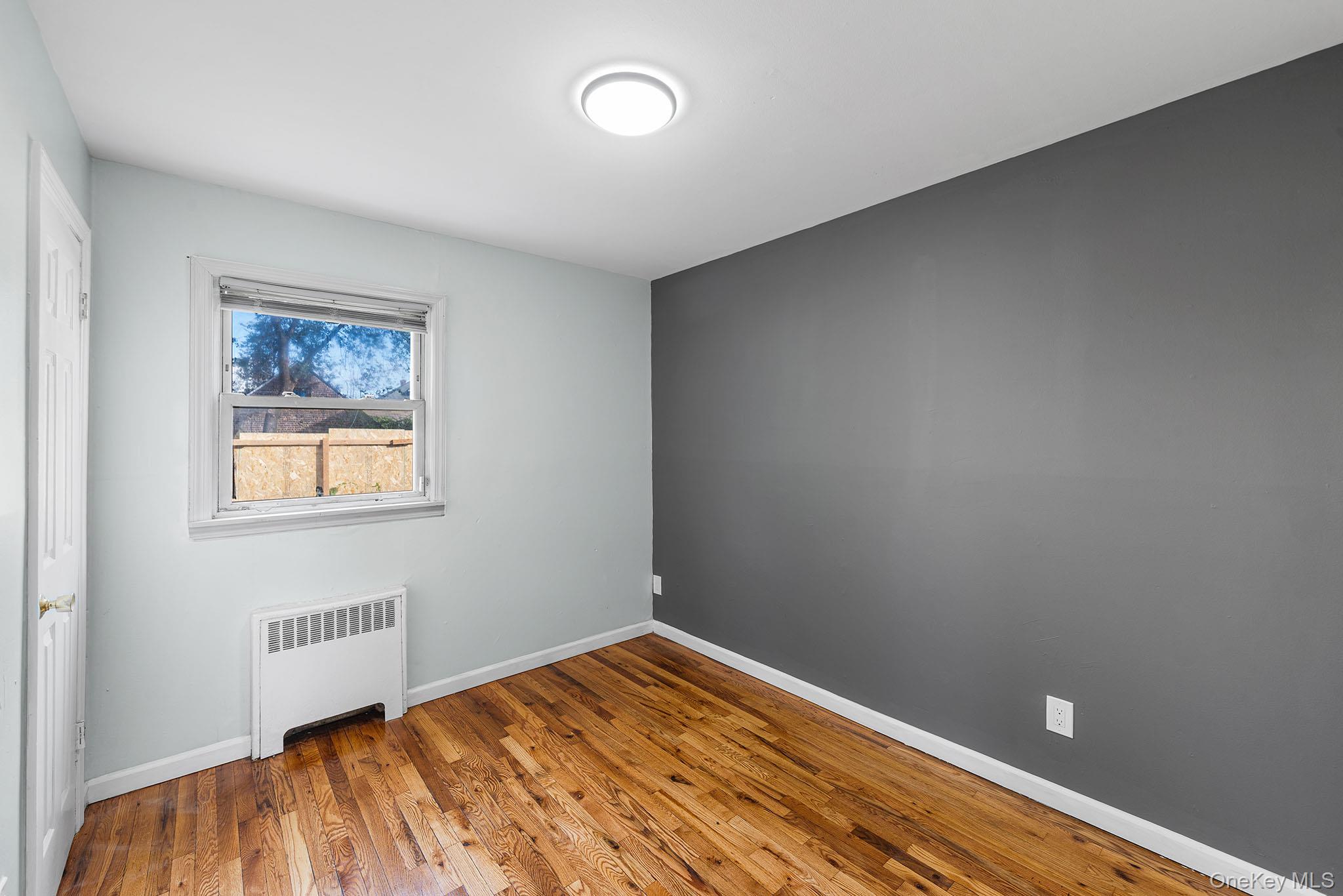 172-04 Amelia Road Queens, NY 11434 - Photo 13 of 25 a bedroom with a bed and a window