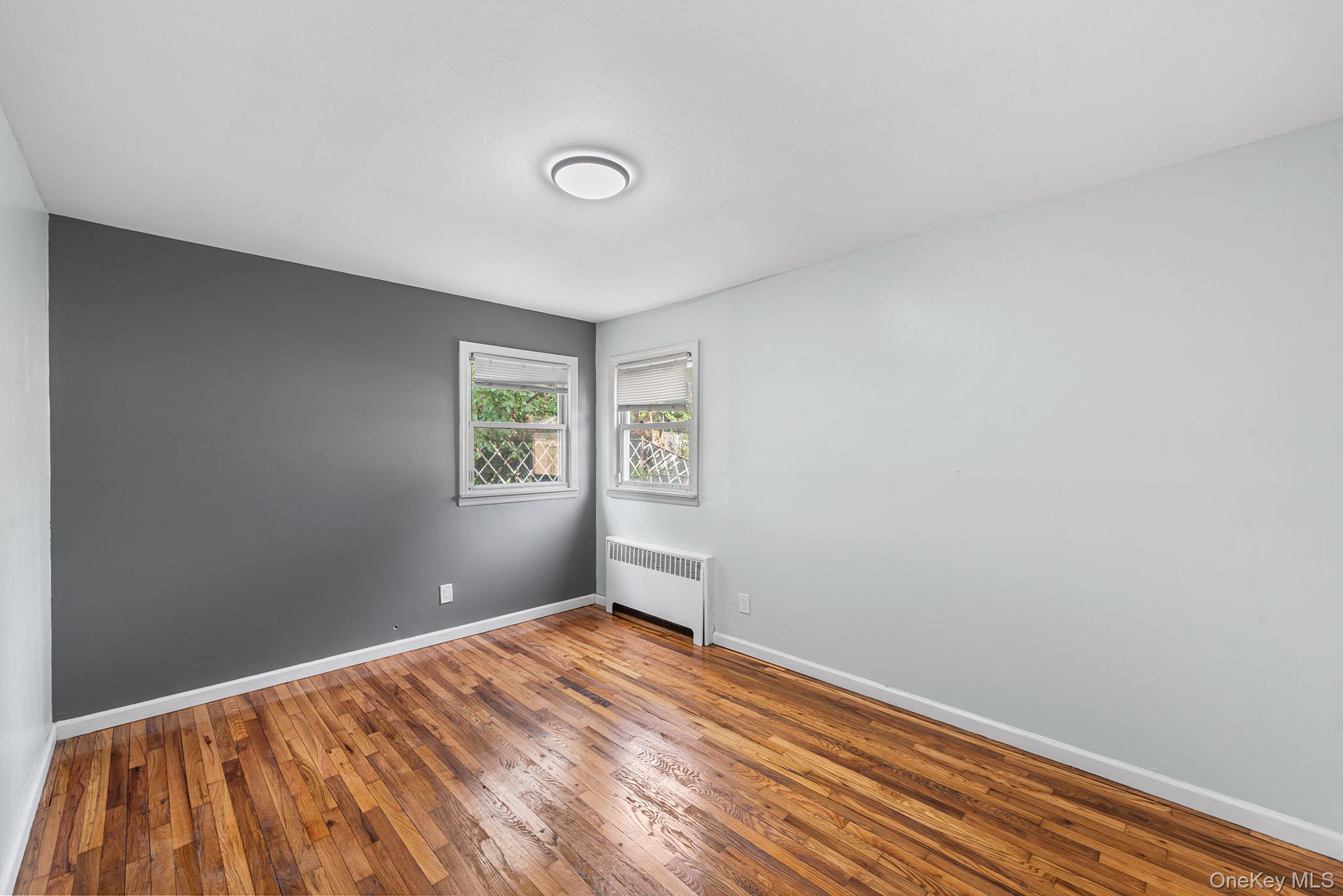 172-04 Amelia Road Queens, NY 11434 - Photo 14 of 25 a view of empty room with wooden floor