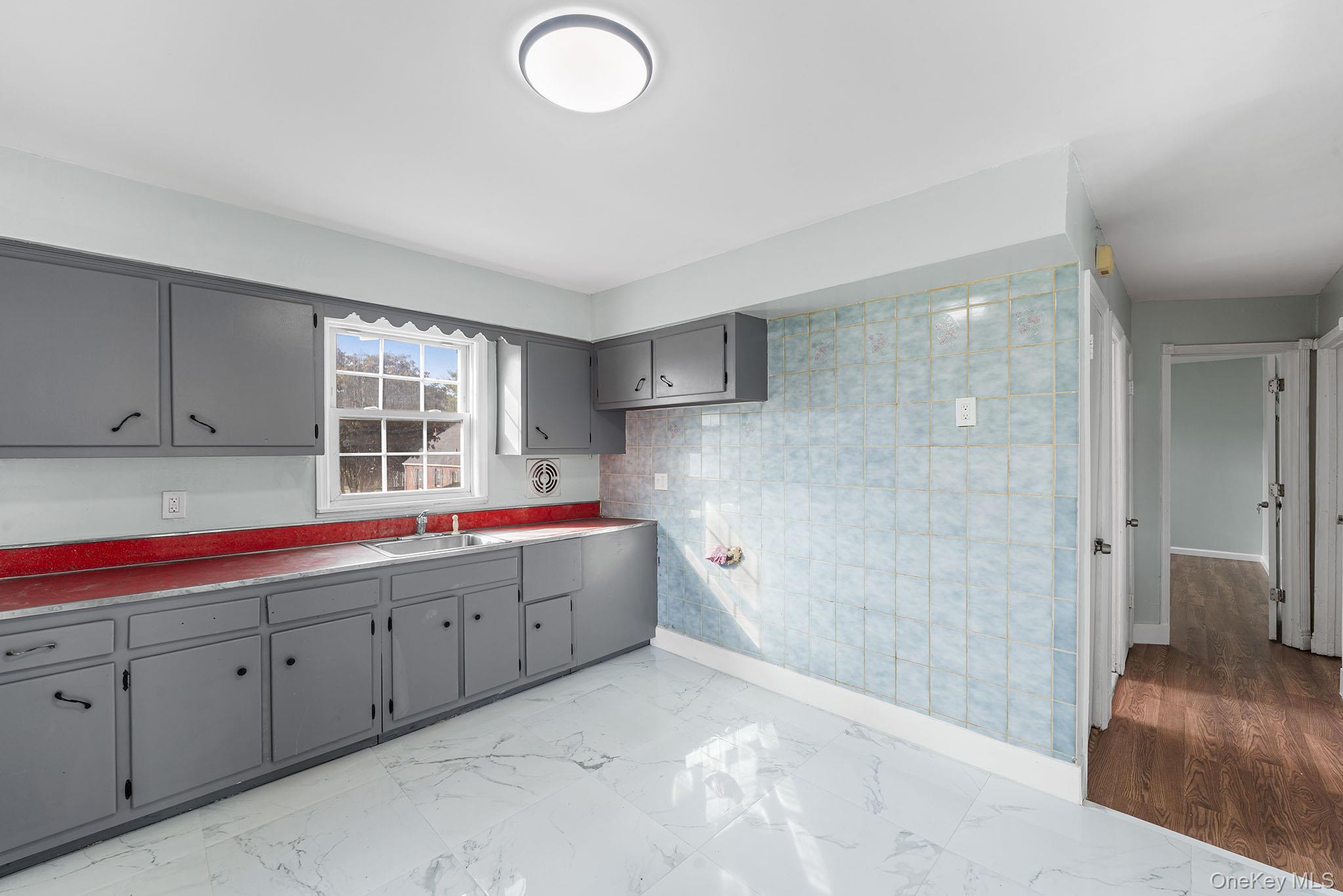 172-04 Amelia Road Queens, NY 11434 - Photo 18 of 25 a bathroom with a tub sink and mirror