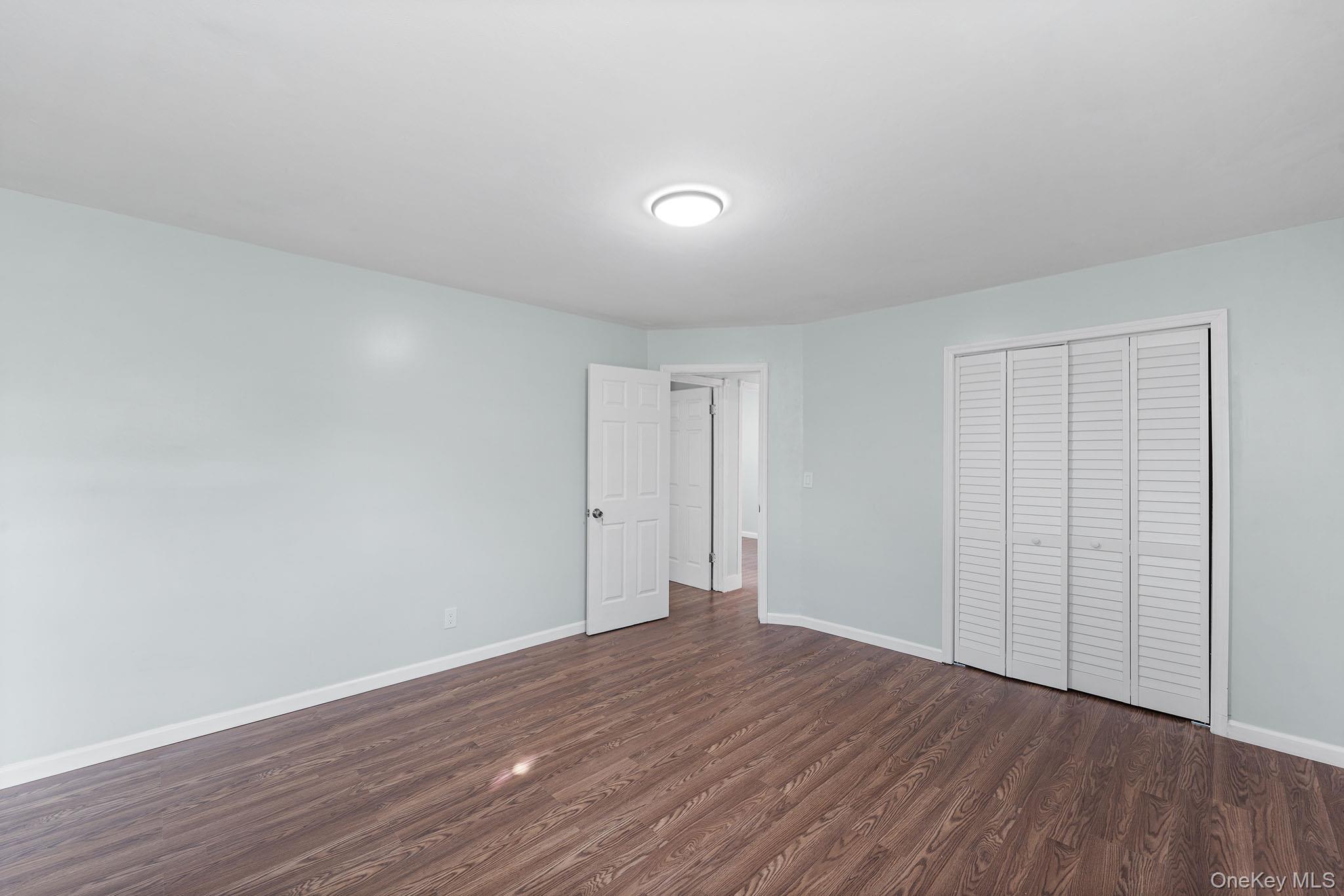 172-04 Amelia Road Queens, NY 11434 - Photo 21 of 25 a view of an empty room with wooden floor