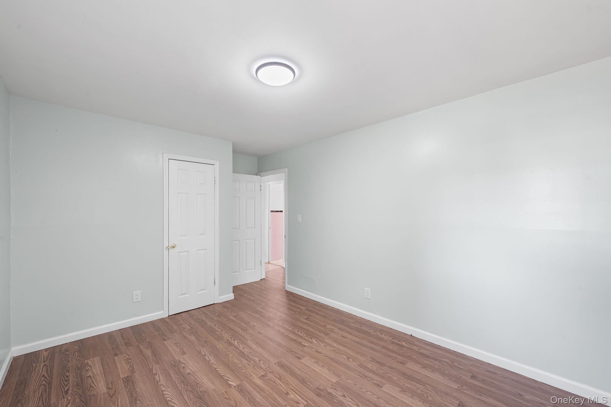 172-04 Amelia Road Queens, NY 11434 - Photo 23 of 25 a view of an empty room with wooden floor