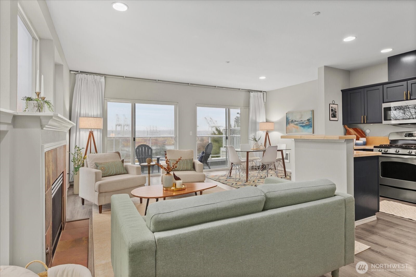 2325 Harbor Avenue Southwest, Unit B1 Seattle, WA 98126 - Photo 11 of 37 a living room with fireplace furniture and a view of kitchen