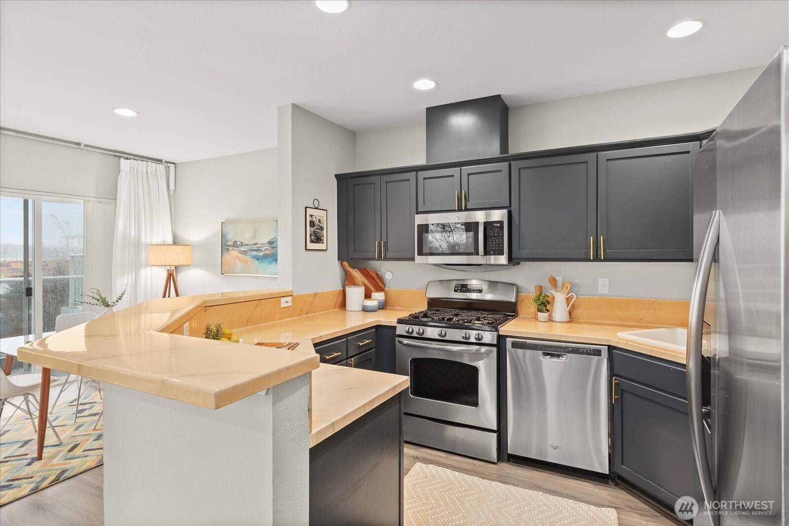 2325 Harbor Avenue Southwest, Unit B1 Seattle, WA 98126 - Photo 14 of 37 a kitchen with stainless steel appliances granite countertop a sink stove and refrigerator